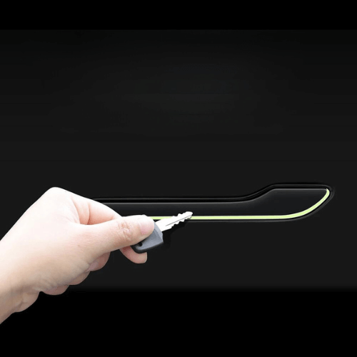 Person installing door handle covering on a Tesla Model 3 or Model Y for enhanced protection and aesthetics.