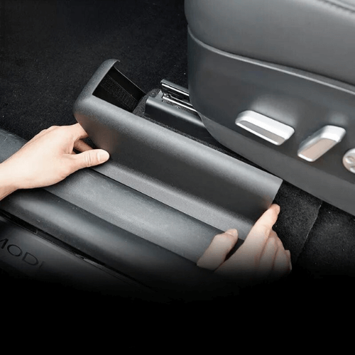 Installing Tesla seat base protection for enhanced durability and cleanliness in electric vehicles.