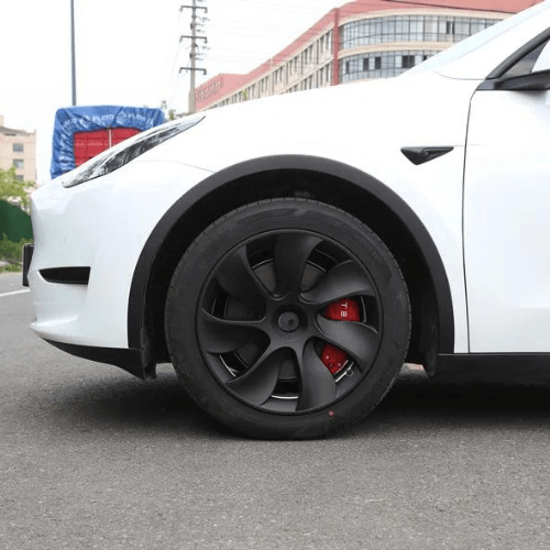 Enjoliveur 19 pouces sur une Tesla blanche, ajoutant une touche d'élégance à son esthétique moderne.