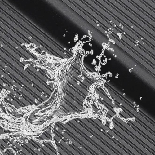 Water splashing on textured surface, showcasing durability and water-resistance of the product.