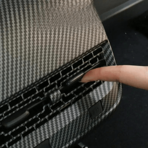 Close-up of textured rear air vent covering in a Tesla, highlighting customization and protection.