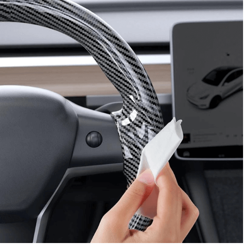 Couvre volant en fibre de carbone pour Tesla Model 3 ou Y, ajoutant confort et style à votre expérience de conduite.