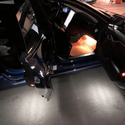Interior view of a Tesla featuring warm LED lighting from the Pack LED Intérieur, enhancing ambiance and visibility.