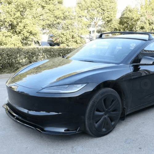 Tesla Model 3 Highland with a sleek custom carbon fiber front spoiler for enhanced aerodynamic performance.