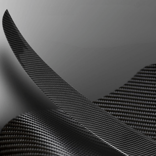 Close-up of a high-quality carbon fiber spoiler for Tesla Model 3, showcasing its sleek design and finish.