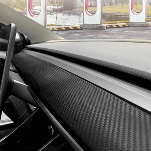 Interior view of a Tesla dashboard featuring a stylish carbon fiber cover for enhanced protection and elegance.