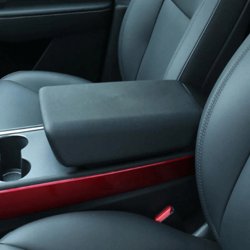 Central armrest in black synthetic leather enhancing Tesla interior comfort and style.