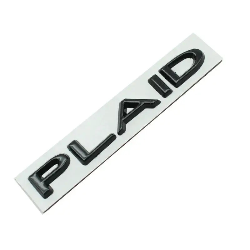 Plaid logo badge for Tesla, showcasing elegance and modern design for electric vehicles.