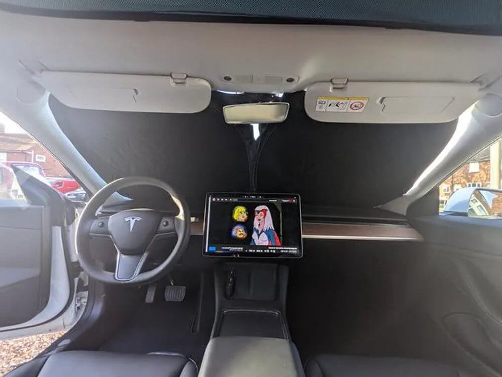 Pare soleil pliable Tesla protégeant contre les rayons UV à l'intérieur d'un véhicule.